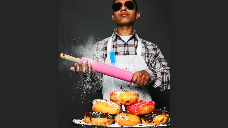 Cool guy with a rolling pin and a plate of donuts